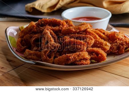 Plate Of Italian Crispy Calamari Rings Appetizer With Marinara Tomato Sauce