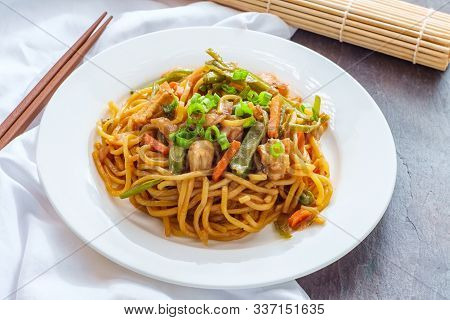 Eating Japanese Chicken Yakisoba Noodles With Chopsticks