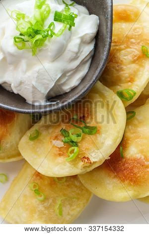 Delicious Authentic Polish Pierogies With Chopped Green Onion And Sour Cream