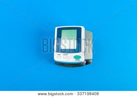 Tonometer For Pressure. Electronic Portable Blood Pressure Monitor. View From Above. On A Blue Backg