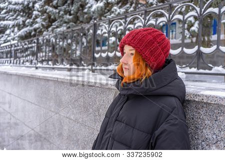 Teen Girl Wearing Casual Clothes Walking On Snow Covered City Street In Winter. Young Lady Spending