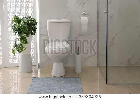 Toilet Bowl Near Shower Stall In Modern Bathroom