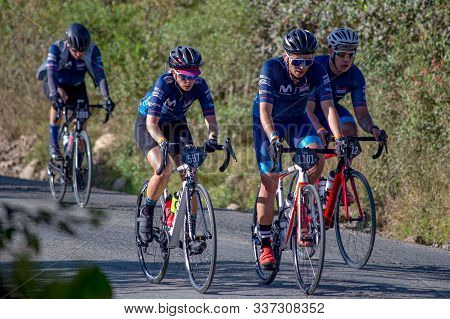 Villa De Leyva, Boyaca, Colombia - December 1, 2019:  Men And Women Of All Ages Ride Bicycles During