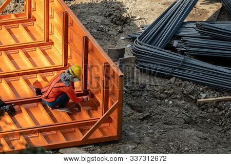 A Construction Worker Do A Job Such As Painting Welding In A Construction Site.