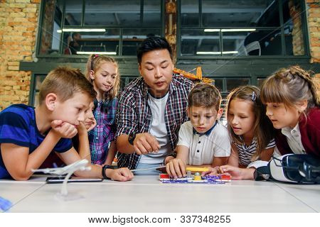 Creative School Children With Young Asian Teacher Study An Electronic Constructor With Fan And Turn 