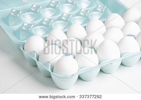 A Close-up Shot Of A Bright Green Styrofoam Crate Full Of White Eggs Set On A White Background.