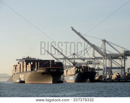Oakland - November 15, 2011:  Msc Shipping Boat Pulled By Tugboats As Another Po Shipping Boat Is Un
