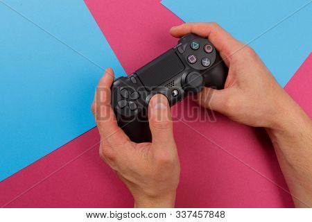 Russia, Oktober 24 2019: Male Hands Holding A Ps4 Controller, Sony Playstation 4 Game Console.