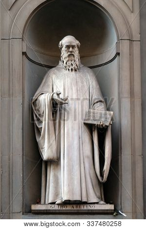 FLORENCE, ITALY - JANUARY 11, 2019: Guido Aretino, statue in the Niches of the Uffizi Colonnade. The first half of the 19th Century they were occupied by 28 statues of famous people in Florence, Italy
