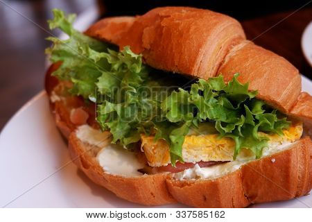 Croissant Sandwiches Served On Wooden Board. Croissants With Egg, Melted Cheese, Parsley, Chicken Ha