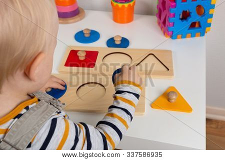 Child Works With Montessori Material For Fine Motor Skills, Sensory Play. Playing Children With Geom