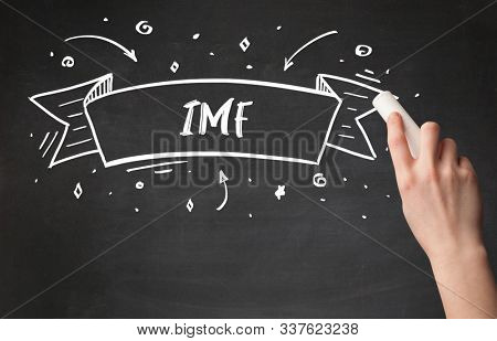 Hand drawing IMF abbreviation with white chalk on blackboard