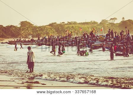 Tanji, The Gambia - November 21, 2019: Scene With Men And Women Carrying Fish From The Boats To The
