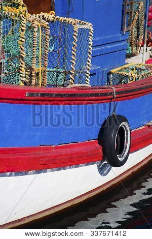 Abstract Of Brightly Coloured Old Wooden Fishing Boat Moored In Kalk Bay Harbour, Cape Town, South A