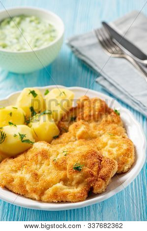 Chop Pork Cutlets , Served With Boiled Potatoes And Tzatziki Dip.