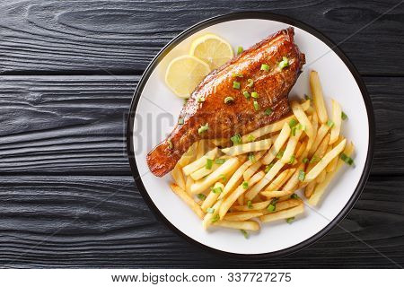 Whole Cooked Sebastes Fish With French Fries And Lemon On A Plate In A Plate. Horizontal Top View