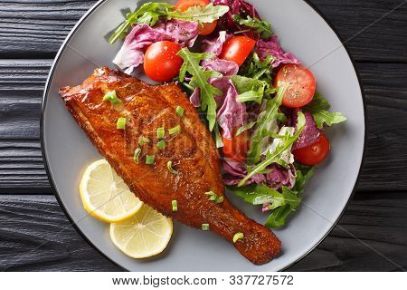 Whole Spicy Fried Sea Perch Served With Fresh Vegetable Salad Close-up In A Plate. Horizontal Top Vi
