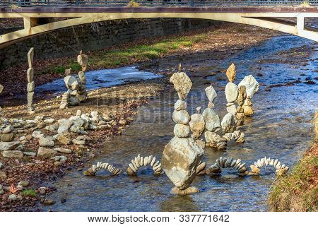 Perfectly Balanced Stones In Towers, Pyramids And Arches. Calm Water And A Balance Of Stones Are Sui