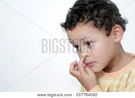 Boy Picking His Nose And Having Fun With White Background Stock Photo