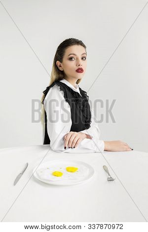 We Are What We Eat. Womans Eating Fried Eggs Made Of Plastic, Eco Concept. There Is So Much Polymers