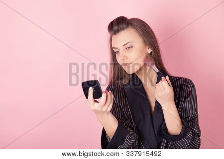 Girl In Coat Makes Brush Makeup Looks In The Mirror