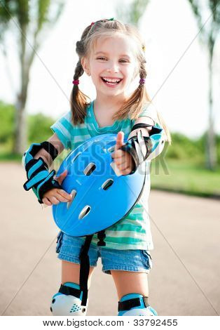 Little girl in roller skates at a park