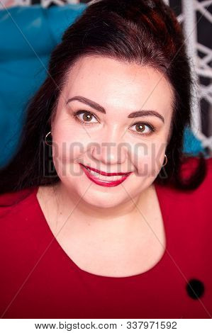 Portrait Of Fat Plump Charming Cute Woman With Black Hair In Red Dress In The Room