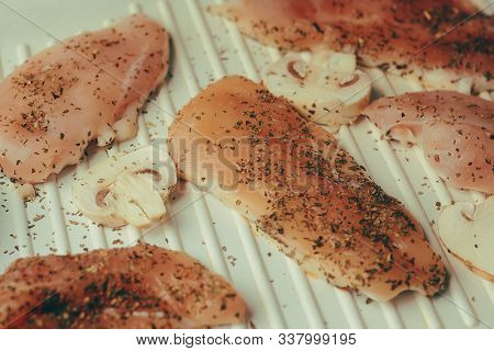 Photo Of Salmon. Fresh Red Fish Rich Color. Mushrooms And Chicken Fillet On The Grill. In Spices, Dr