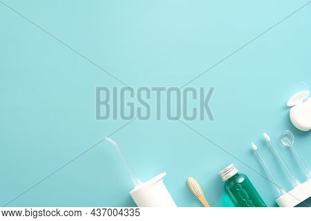Dental Care Products On Blue Background. Flat Lay Composition With Water Flosser Irrigator, Mouthwas