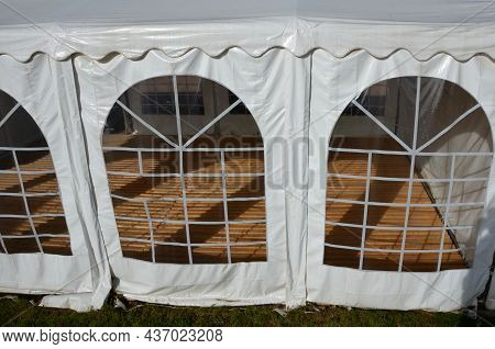 Plastic Tent With Wooden Floor. Party Tents Are Often Impromptu Rooms For Vaccinating And Testing Pa