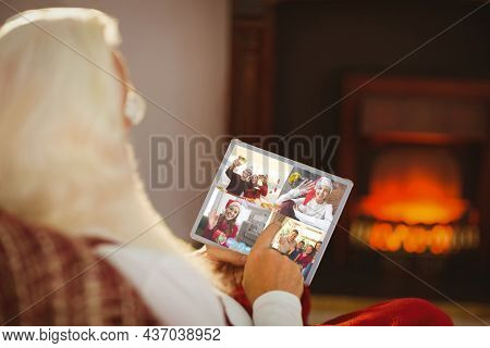 Caucasian santa claus on christmas laptop video call with diverse group of friends. christmas, festivity and communication technology.