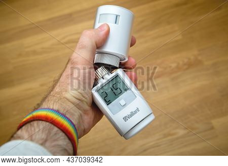 Paris, France - Apr 24, 2021: Pov Male Hand Holding Vaillant Thermostatic Radiator Connected By Inte