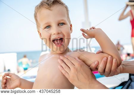 Mother Applying Sunscreen Protection Creme On Cute Little Baby Boy Kid Hand. Mum Using Sunblocking L