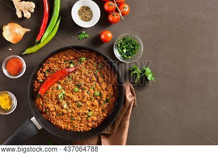 Keema Curry In Frying Pan Over Dark Background With Copy Space. Indian And Pakistani Style Dish. Top