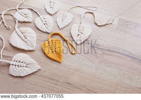 Macrame Leaves In Yellow  And Natural Color On The Wooden Background. Cotton Rope Decor Macrame To M