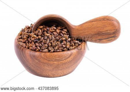 Cassia Tora Beans In Wooden Bowl And Spoon, Isolated On White Background. Sicklepod Or Senna Obtusif