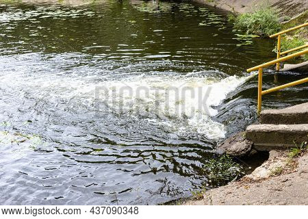 Discharge Of Water From Underground River Into City Pond
