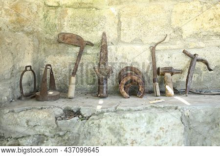 The Exhibition Of Blacksmith Craft Work Examples On The Wall In Local Ethnological Museum . Old Rust