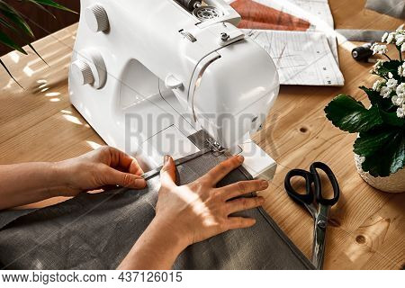 Seamstress Sewing The Linen Fabric On The Sewing Machine In Small Studio. Fashion Atelier, Tailoring