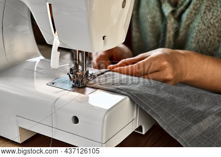 Seamstress Sewing The Linen Fabric On The Sewing Machine In Small Studio. Fashion Atelier, Tailoring