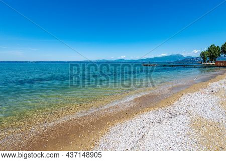 Beauty Empty Beach On Lake Garda (lago Di Garda) With Wooden Piers, Near The Small Villages Of Lazis