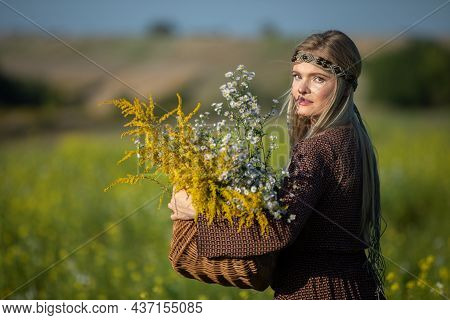 A Young Woman Collected Goldenrod And Winterberry In A Basket. Treating With Herbs.