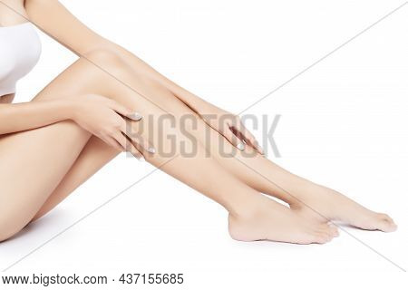 Young Woman Legs With Slim Body, Soft Clean And Smooth Skin On White Background And Copy Space.