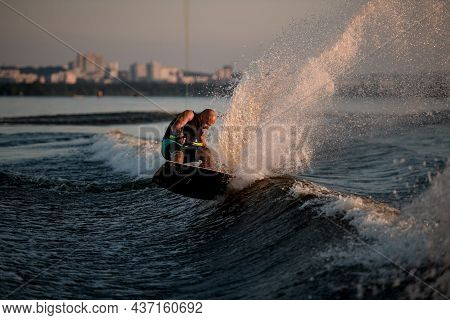 Strong Man Trying To Stand On Splashing Wave On A Wakeboard