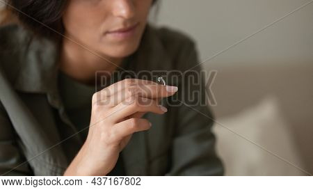 Depressed Sad Young Woman Taking Off And Holding Wedding Ring