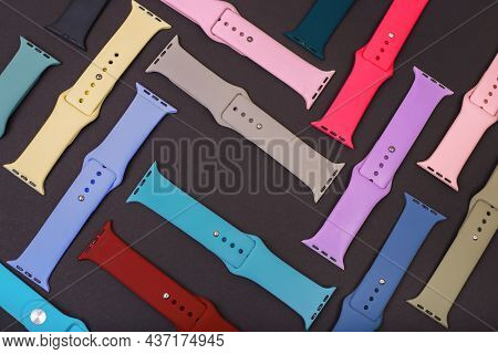 Colorful Silicone Straps For Smart Watches On A Black Background. Flat Lay, Different Straps For Wat