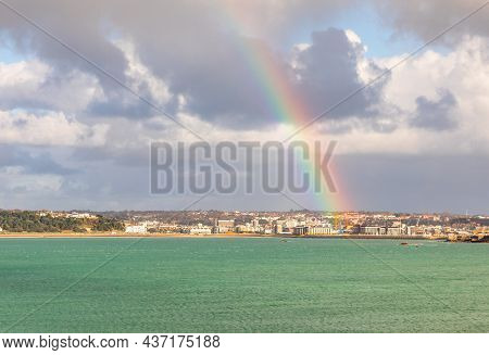 Rainbow Over Saint Helier Capital City With Sea In The Foreground, Bailiwick Of Jersey, Channel Isla