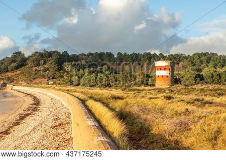 Saint Brelade British Round Coastal Defence Tower Standing On The Coast With German Defence Barrier,