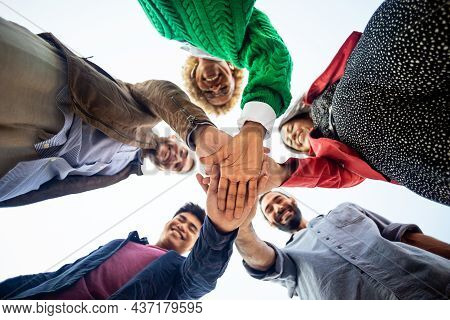 United Diverse Happy Young People Stacking Hands - College Students Teamwork Celebrating Together In