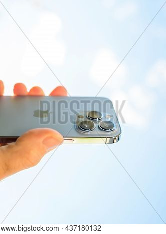 Paris, France - Oct 21, 2021: Male Hand Offering Latest Apple Computers Iphone 13 Pro With All Three